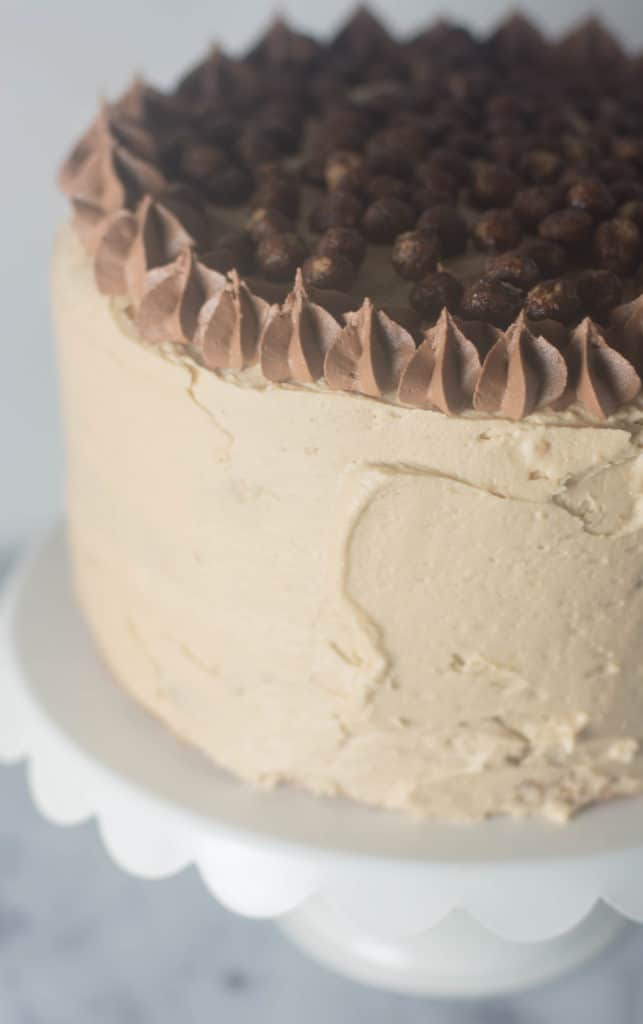 Vanilla Bean Peanut Butter Crunch Cake--vanilla cake topped with peanut butter frosting, filled with rice krispies, white chocolate, and (yes) peanut butter