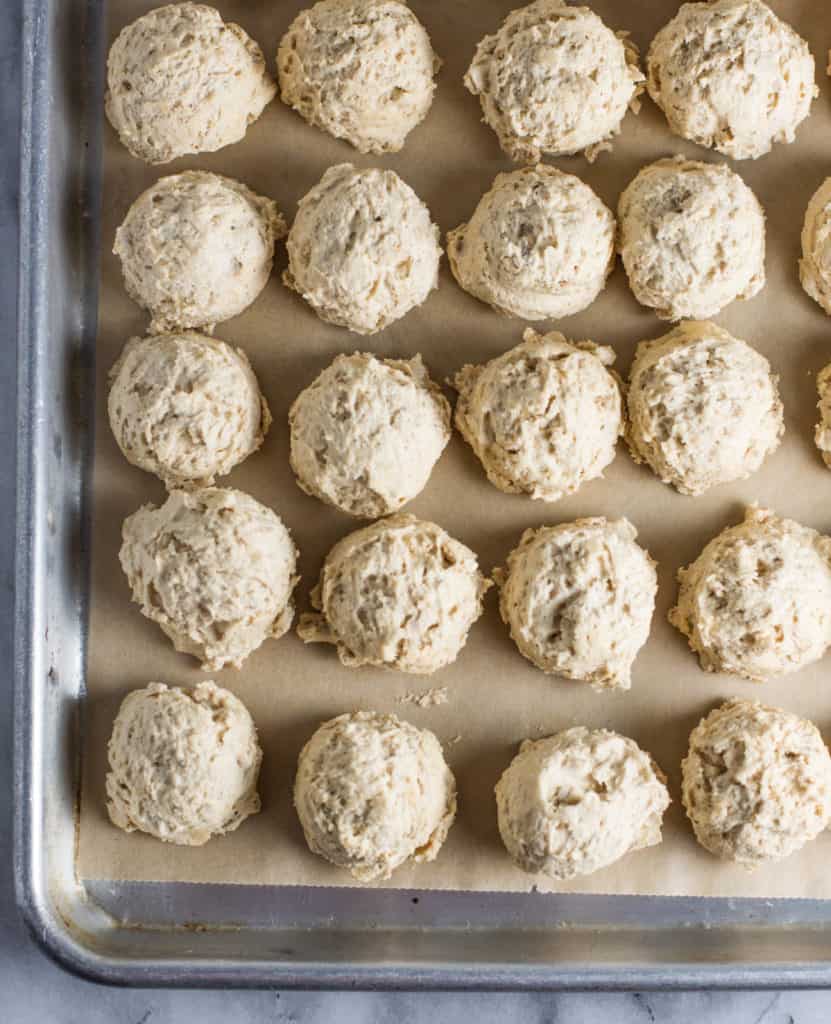 balls of dough for the chocolate peanut butter sandwich cookies on a baking sheet