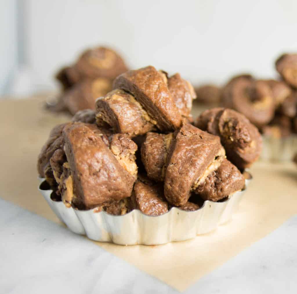 chocolate peanut butter rugelach cookies sitting in a tart shell