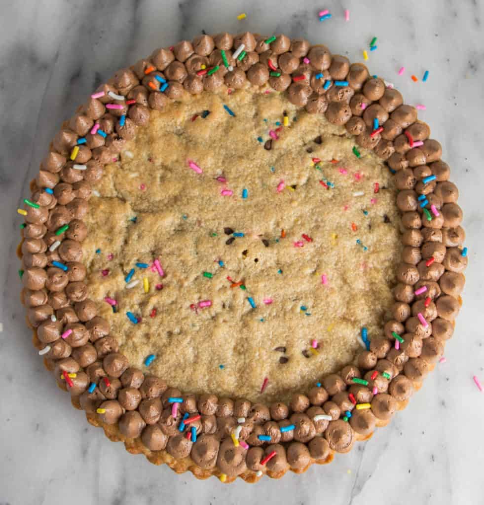 overhead shot of the funfetti peanut butter cookie cake with piped chocolate frosting