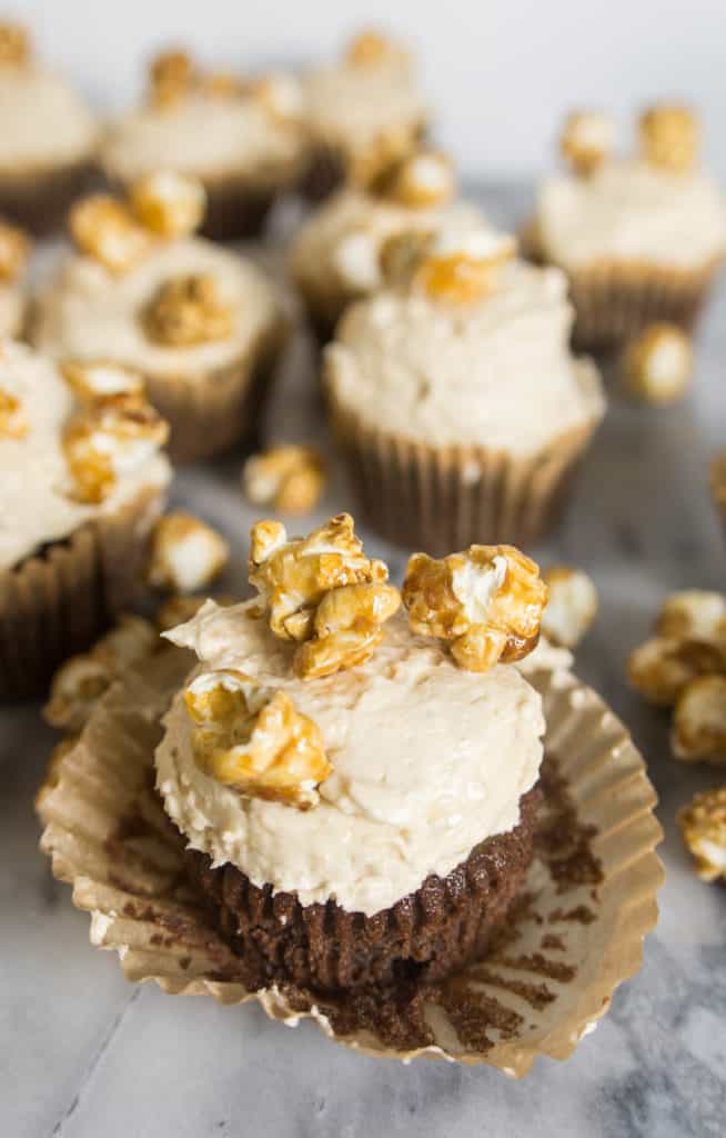 chocolate caramel corn cupcake with the cupcake liner peeling off