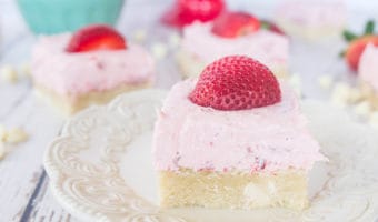 With a chewy cookie base and a creamy frosting on top, these sugar cookie bars with roasted strawberry buttercream are the perfect dessert to end any summer meal.