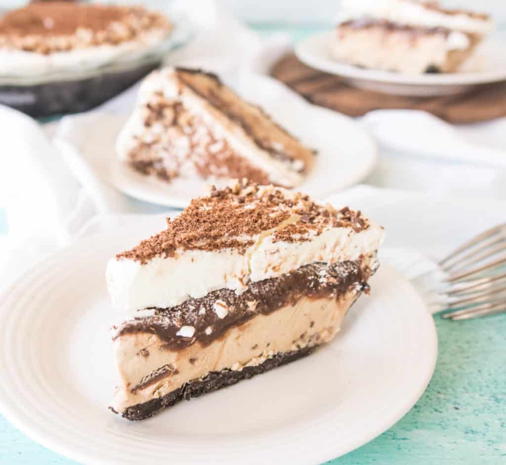 slice of coffee-toffee ice cream pie on a plate with more slices of pie in the background