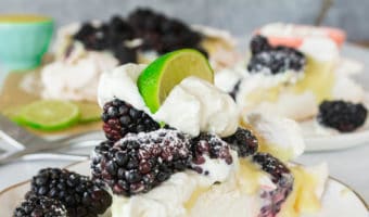 Crispy on the outside, soft and marshmallow-soft on the inside, this blackberry, lime, and cardamom pavlova recipe is summer dessert at its most delicious.