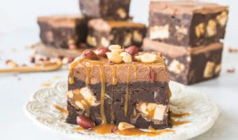 Recipe for fudgy Snickers brownies with whipped chocolate ganache frosting. They're decadent, rich, and they're the most fudgy brownies EVER! #chocolate #brownies