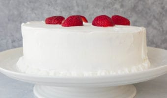 This strawberry shortcake layer cake is packed with strawberries and frosted with whipped cream; it tastes just like strawberry shortcake, but it’s a little more fluffy! This recipe uses a box cake mix for ease but you can use your favorite white or yellow cake recipe.