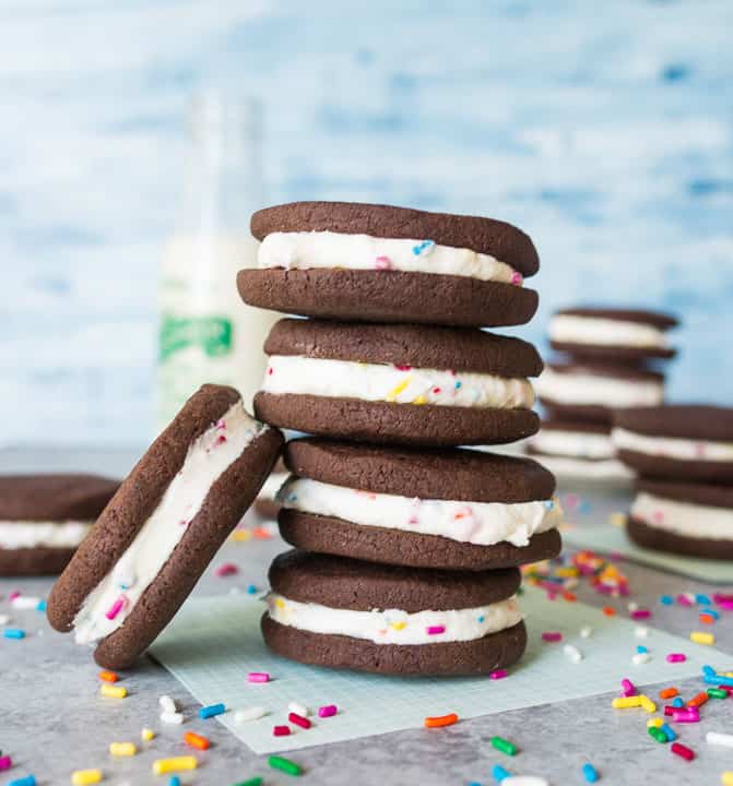 stack of cake batter chocolate sandwich cookies on a piece of parchment