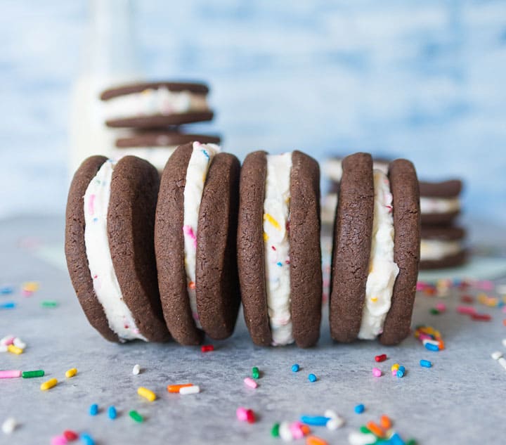 cake batter chocolate sandwich cookies side by side with sprinkles scattered around them