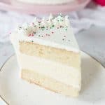 White chocolate eggnog cheesecake layer cake is the show-stopping holiday dessert you’ve been searching for. It’s sweet and delicious and packed with holiday flavors! recipe via itsybitsykitchen.com #Christmas #eggnog #layercake