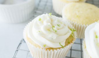 margarita cupcakes on a wire rack with salt and a lime in the background