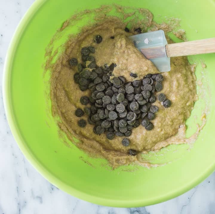 mixing bowl with spatula mixing the chocolate chips into the batter for paleo chocolate chip banana bread