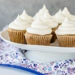 zucchini cupcakes with cream cheese frosting on a cake stand