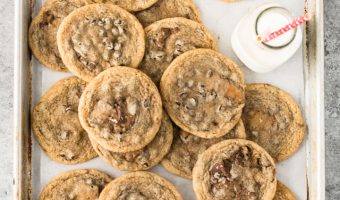 overhead shot of Rolo cookies on a a baking sheet with a bottle of milk next to them