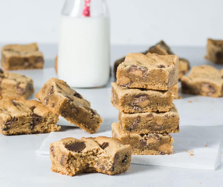 stack of peanut butter cookie bars with one bar in front of the stack