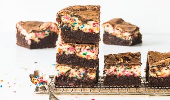 stack of birthday cake brownies with more brownies behind