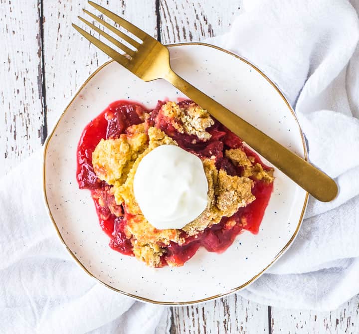 overhead shot of rhubarb dump cake on a plate sitting on top of a white towel