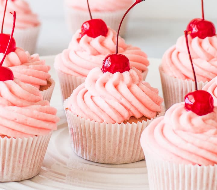 cherry cupcakes on a cake stand
