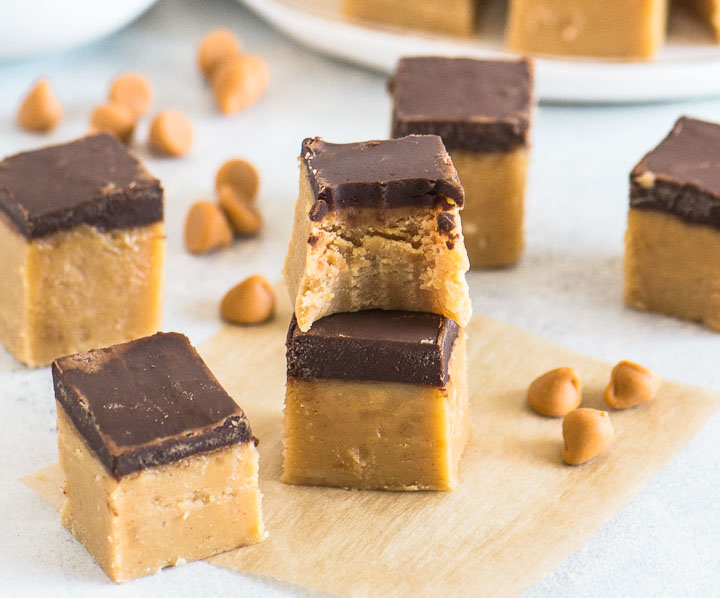 two squares of fudge stacked, with a bite taken out of the top square and more fudge around it