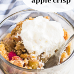 pinterest image with crisp in a bowl topped with whipped cream
