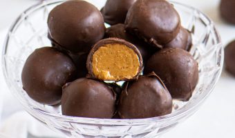 truffles in a glass dish with one cut in half to show the filling