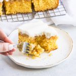 fork taking a bite from a slice of Elvis Presley Cake with more slices of cake on a wire rack in the background