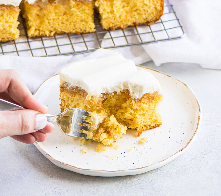 fork taking a bite from a slice of Elvis Presley Cake with more slices of cake on a wire rack in the background