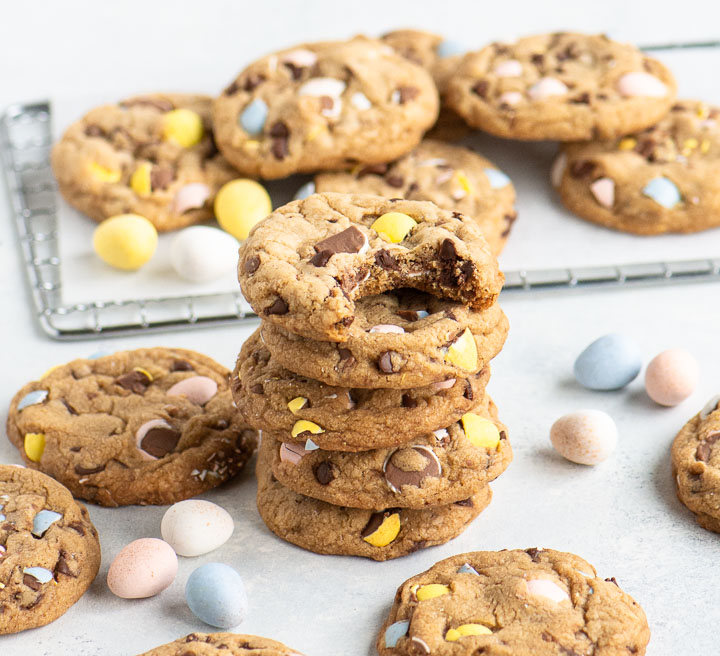 stack of cookies with Cadbury mini eggs and more cookies arranged around and behind them
