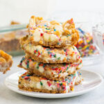 stack of birthday cake bars on a white plate